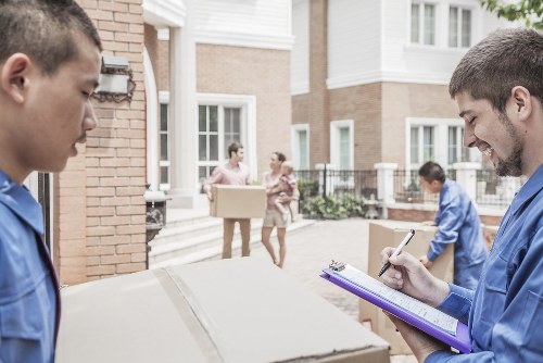 Professional movers handling office equipment